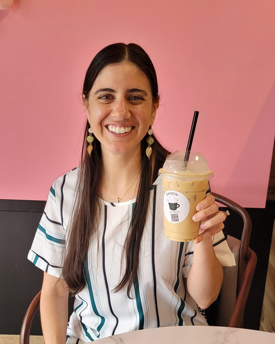 Ashley Billins, REALTOR® in Copperas Cove, TX, smiling with an iced coffee at a local coffee shop